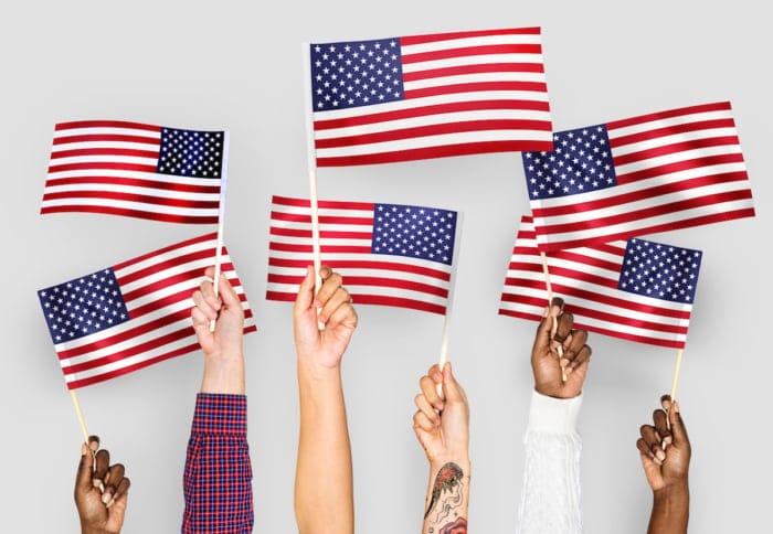 Hands Raising US Flags