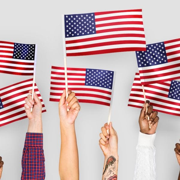 Hands Raising US Flags