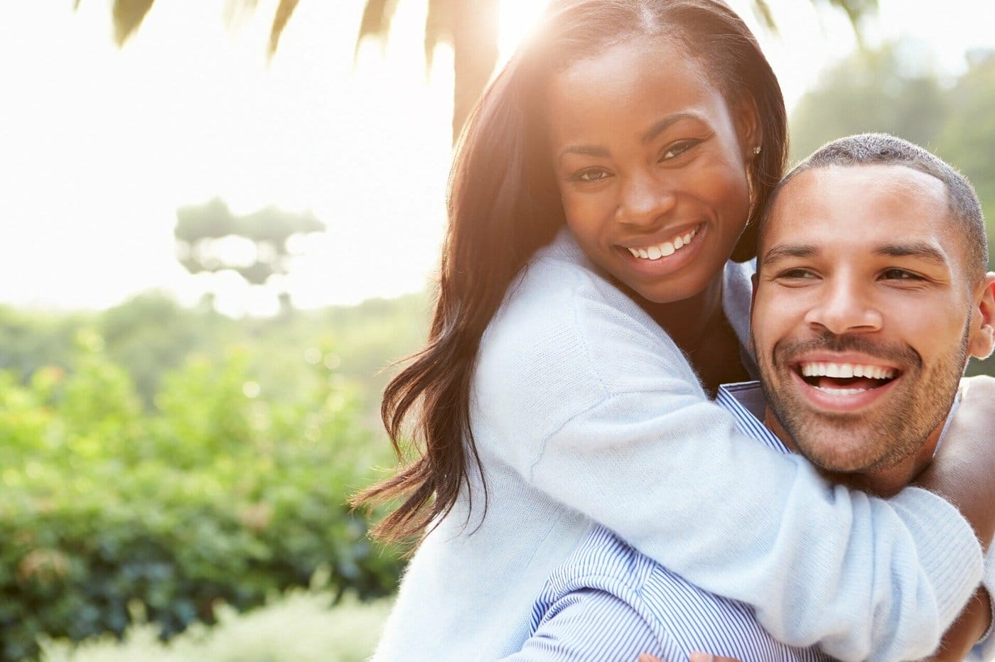 A couple hugging and laughing together.