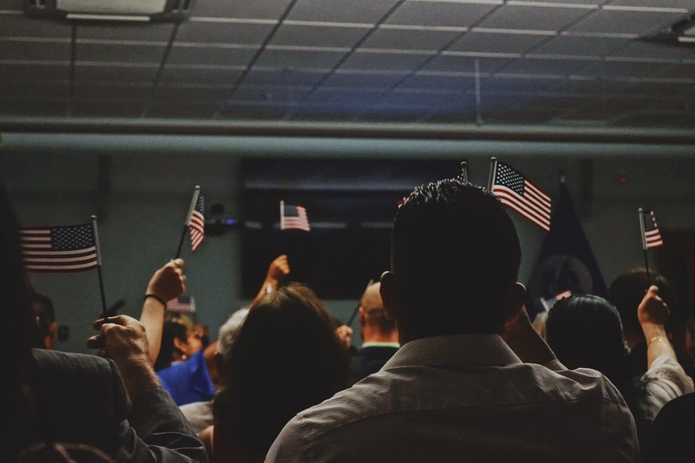 New American citizens waving the American flag.