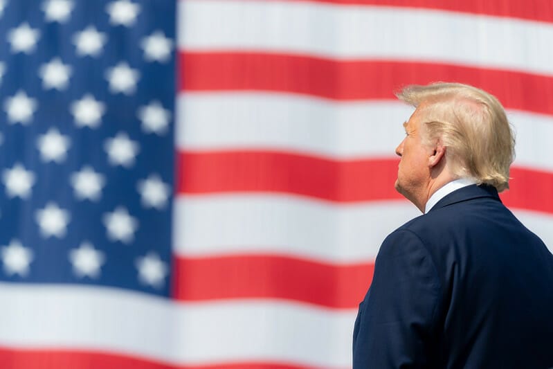 Impeached President Donald Trump in front of American flag