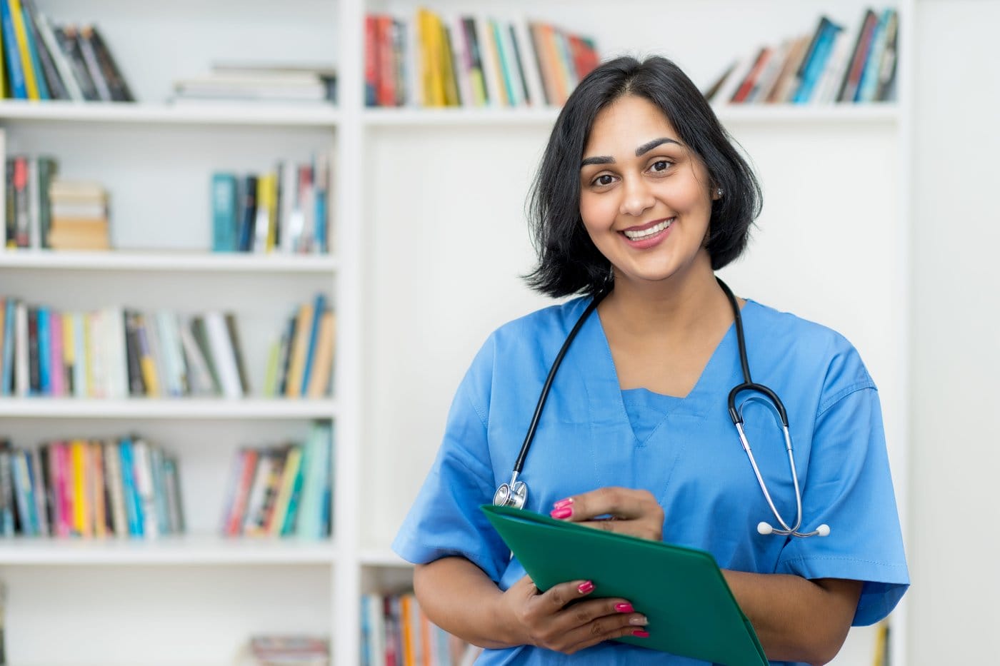 An immigrant doctor holds a clipboard.