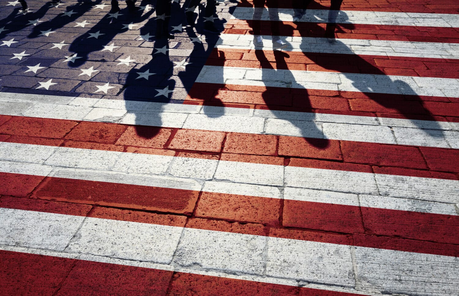 U.S. immigrant Shadows on a flag-painted paved street