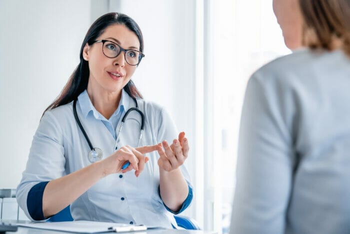 A doctor perform an immigration medical exam.