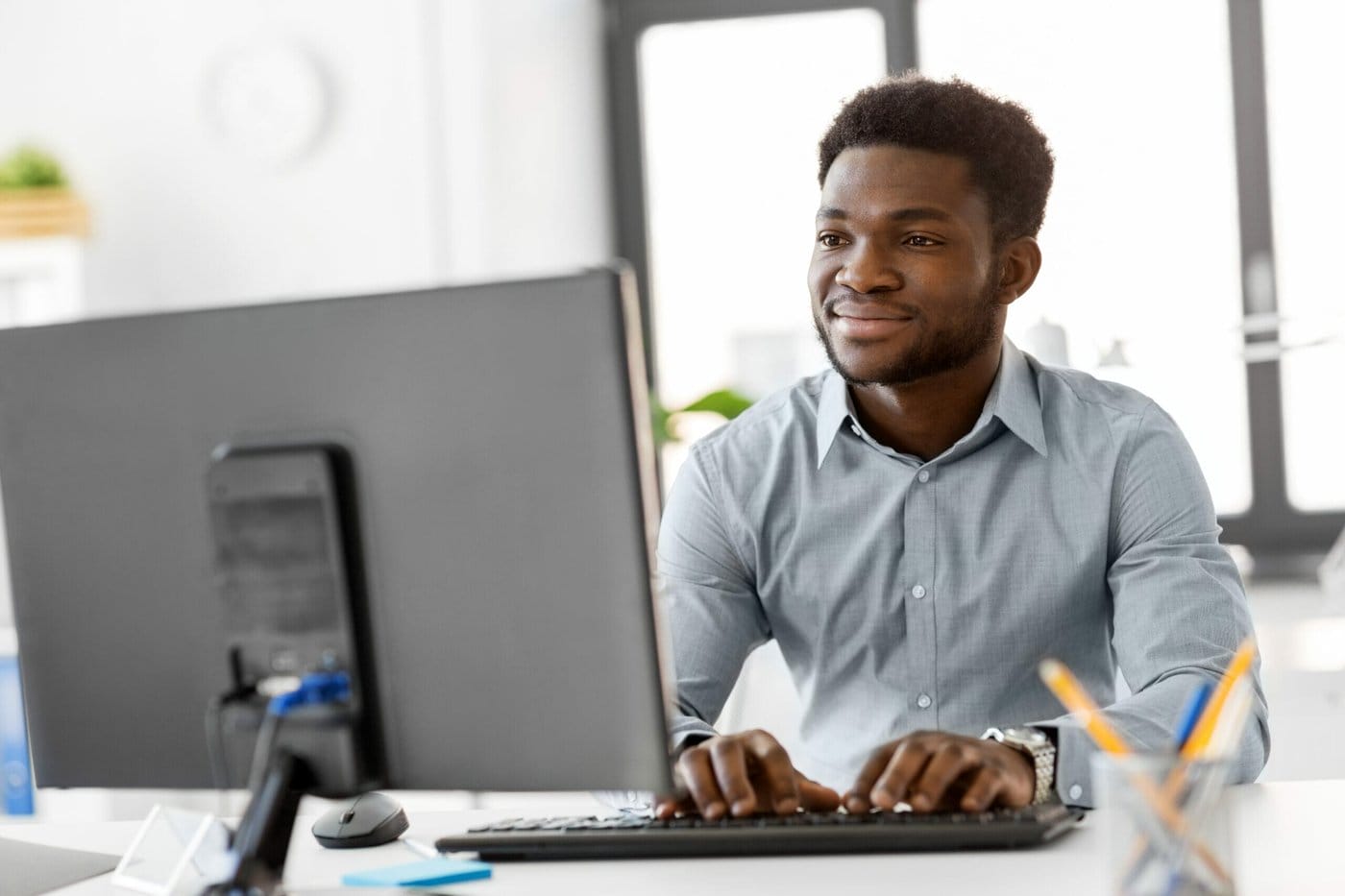 african businessman with computer at office Man files his U.S. immigration form online