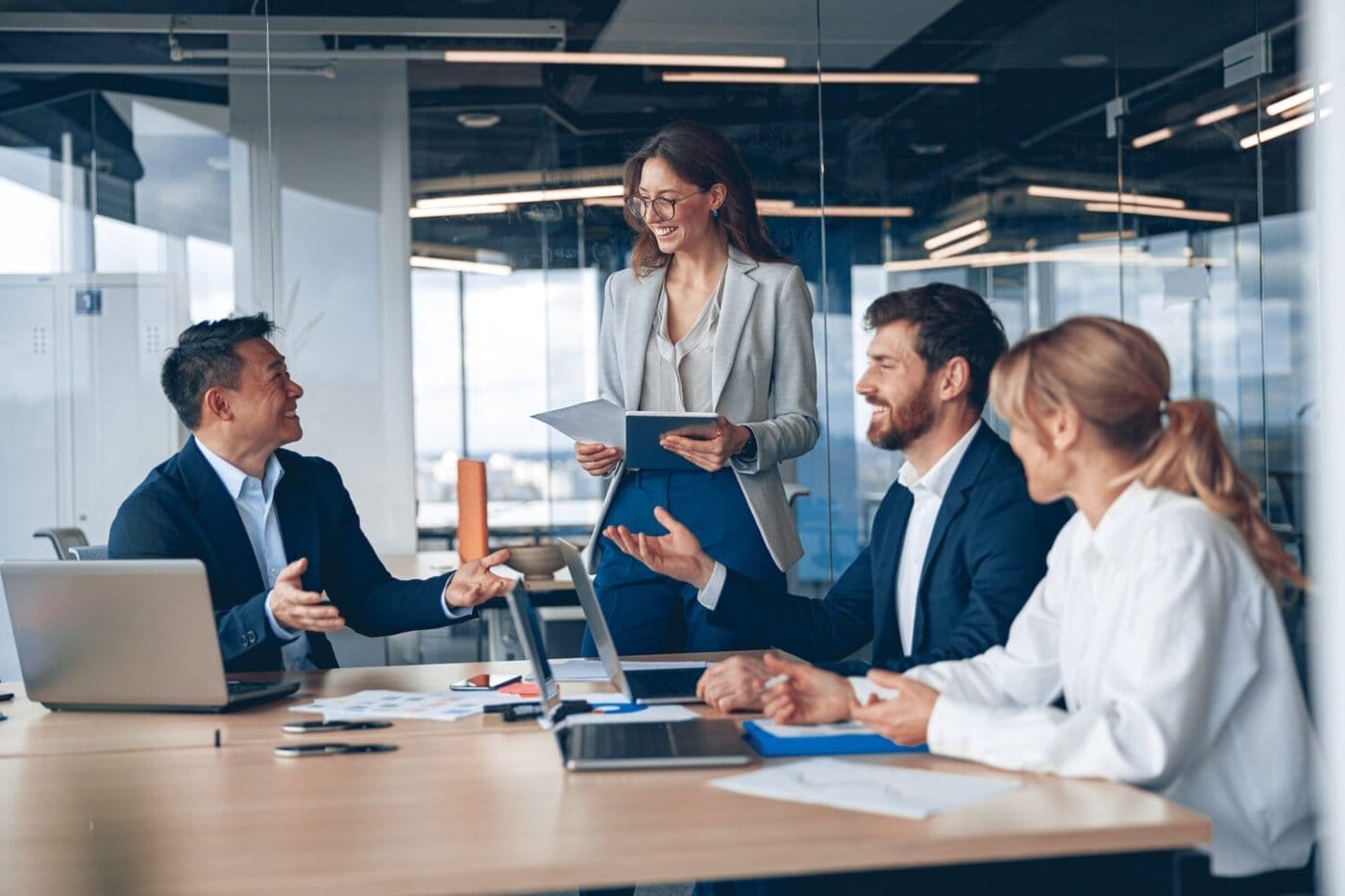 H-1B workers chat in an office